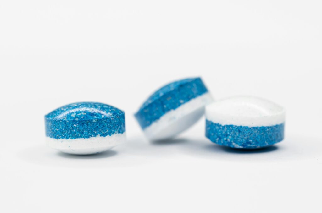 Abstract photo of blue and white pills with a focus on healthcare and medication concepts.